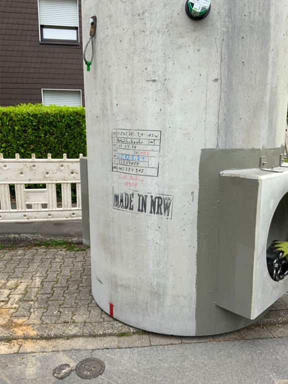 Auf dem Foto sieht man einen Lamellenklärer auf der Straße stehend, bevor er in das Bauloch gehoben wird.